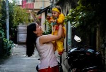 mother holding baby in traditional costume