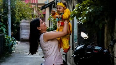 mother holding baby in traditional costume